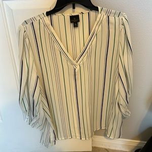 White blouse with green and black lines.